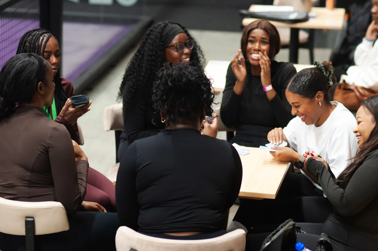 Group of women socialising and laughing at a Shot4Shot Padel event